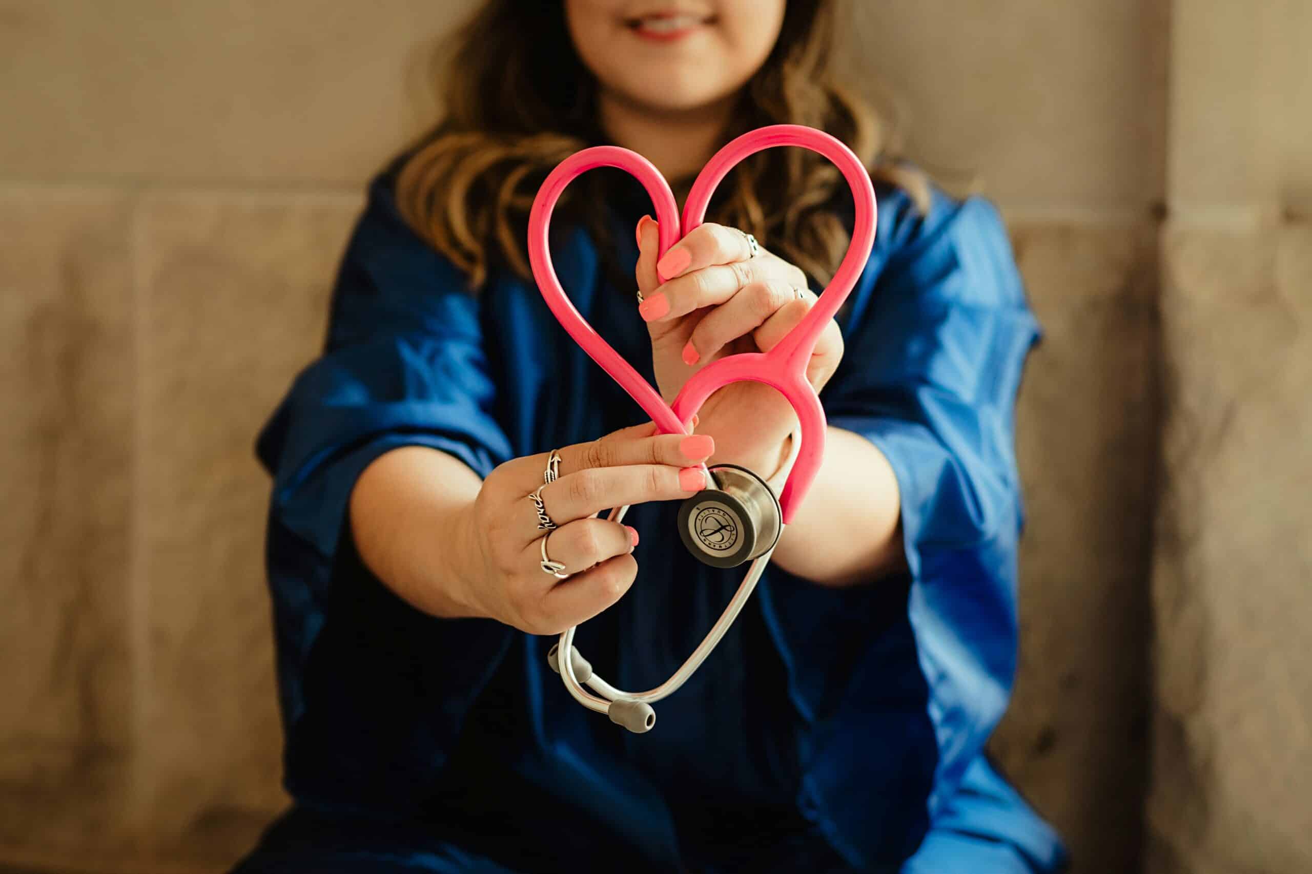 A healthcare professional in a white lab coat holding a stethoscope